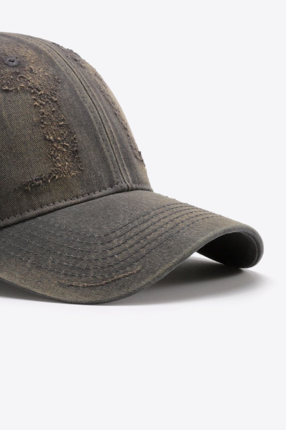 Distressed baseball cap in dark gray with frayed details and stitched brim.