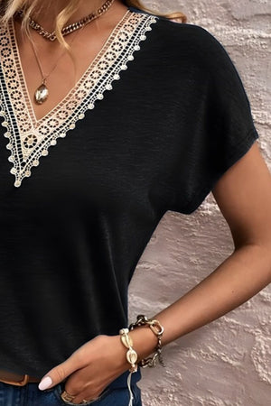 Black dolman sleeve top with lace trim V-neck detail
