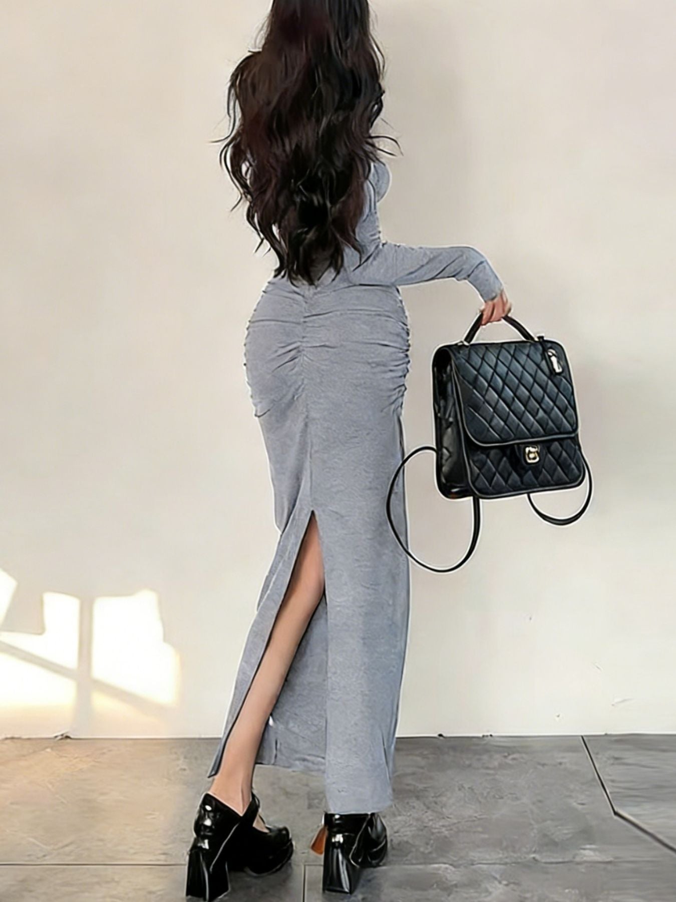 Light gray ruched long-sleeve bodycon maxi dress with a thigh-high slit.