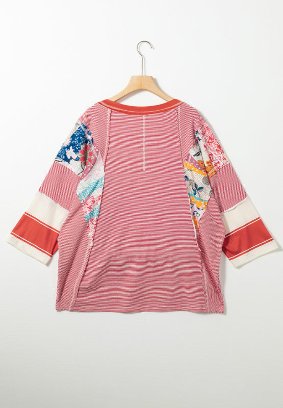 Patchwork stripe raglan sleeve tee in red with colorful boho print accents and contrast cuffs.