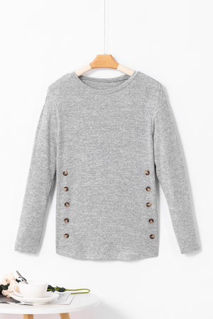 Dark gray slouchy knit top with side button details and long sleeves.