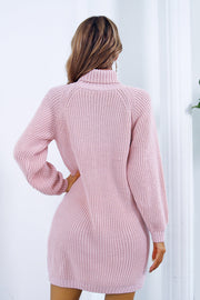 Pink acrylic knit turtleneck mini dress with long balloon sleeves.