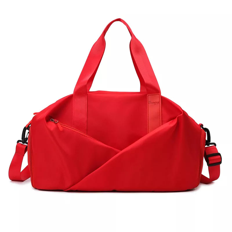 Red nylon travel bag with adjustable strap and zippered front pocket.