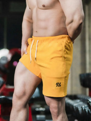 Gold performance shorts with drawstring and logo detail
