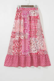 Printed tiered maxi skirt in dusty pink with patchwork floral and geometric patterns and a ruffled hem.