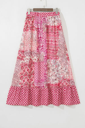 Printed tiered maxi skirt in dusty pink with patchwork floral and geometric patterns and a ruffled hem.