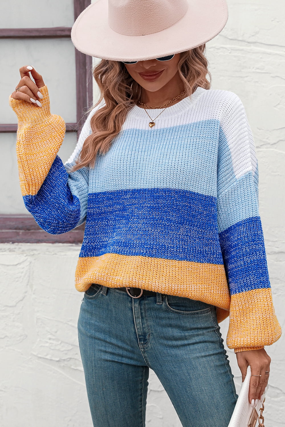 Striped acrylic sweater with balloon sleeves in blue, white, and yellow, crew neck.