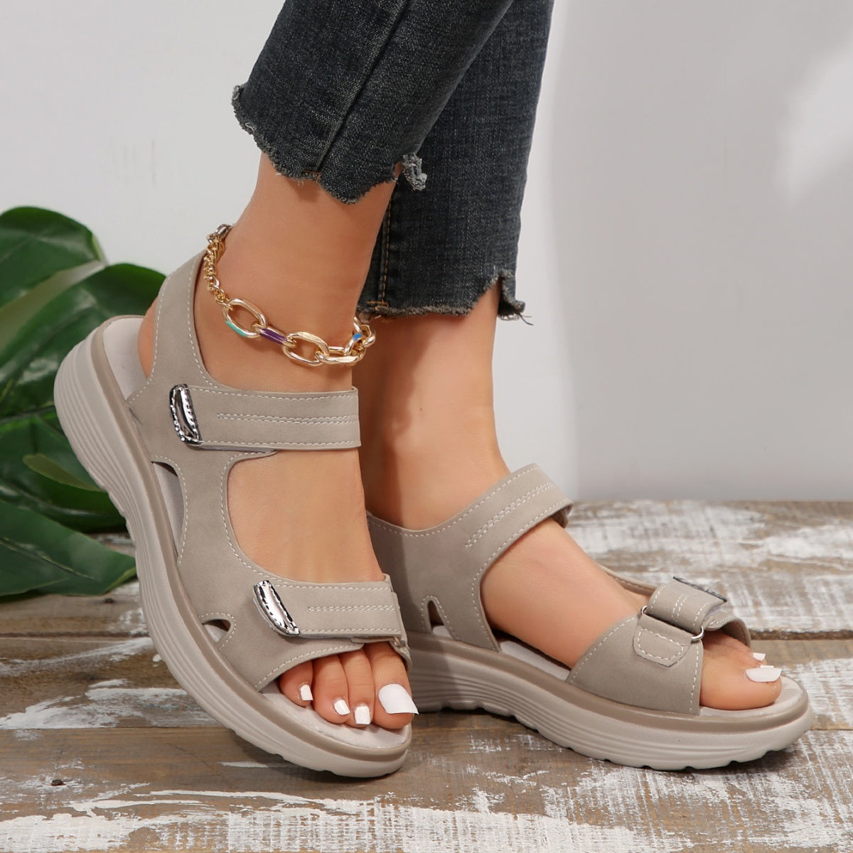 Gray adjustable open-toe sandals with contrast stitching and buckle detail.