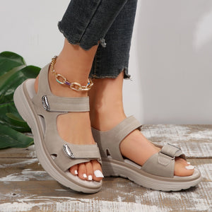 Gray adjustable open-toe sandals with contrast stitching and buckle detail.