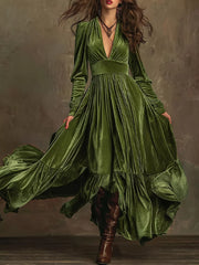 Dark green velvet maxi dress with voluminous sleeves, deep V-neck, and ruffled hem.