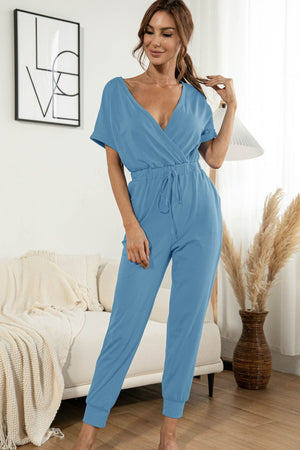 Sky blue surplice waist jumpsuit with short sleeves and drawstring.
