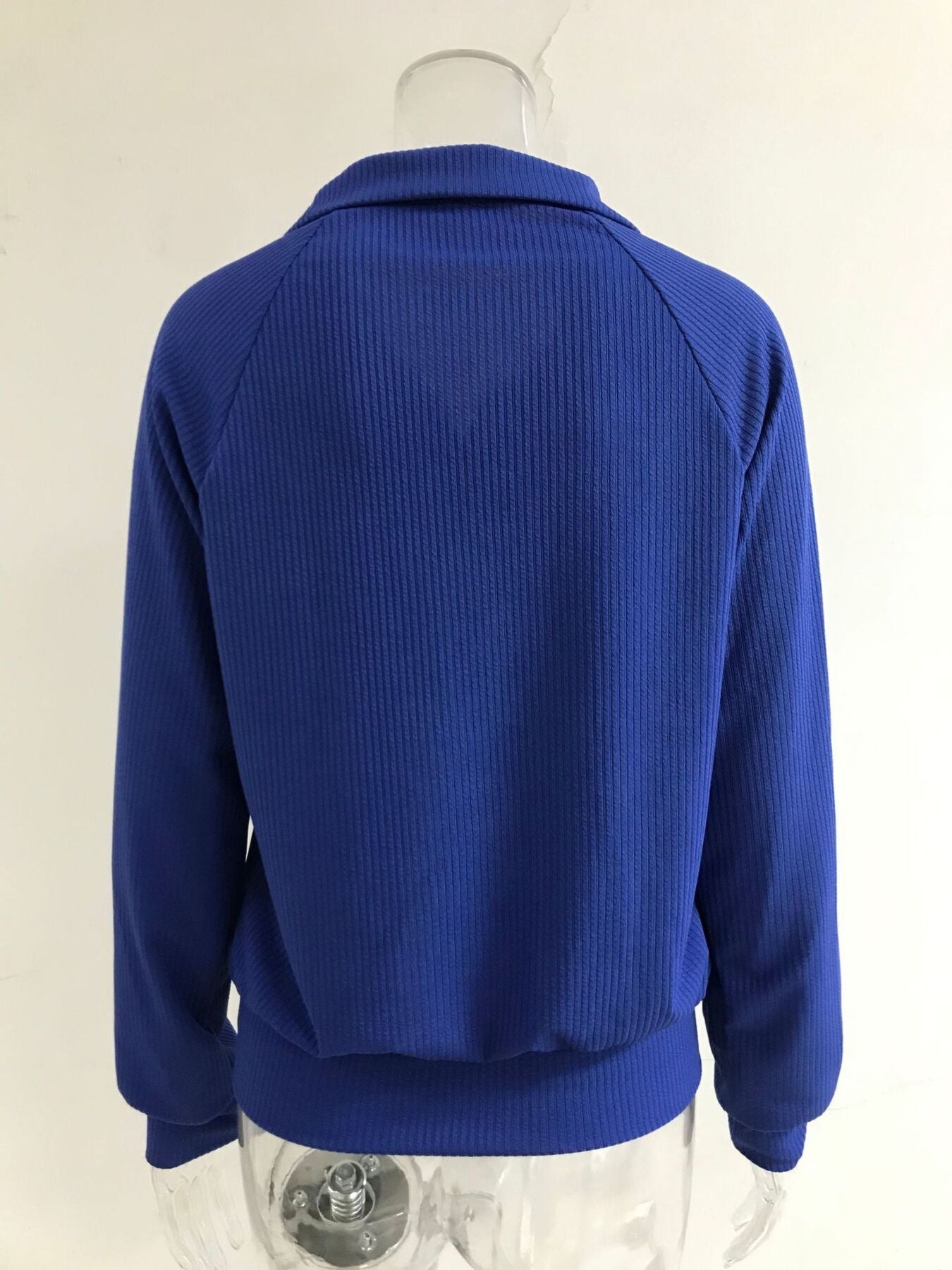 Blue ribbed knit plus size trench coat with a collar and long sleeves.