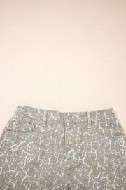 Denim shorts with a subtle leopard print in grey and tan, featuring a button fly and front pockets.