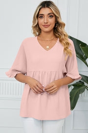 Gathered yoke flutter sleeve blouse in watermelon pink with v-neck and ruffled cuffs.
