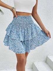 Smocked floral tiered mini skirt in sky blue with ruffled tiers.