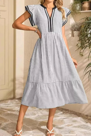 Striped midi dress with ruffle sleeves and tiered hem in black and white.