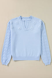 Sky blue knit sweater with embroidered floral details and notch neck.