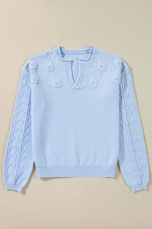 Sky blue knit sweater with embroidered floral details and notch neck.
