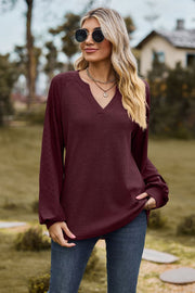 Burgundy waffle knit raglan top with laser cut sleeves and v-neck