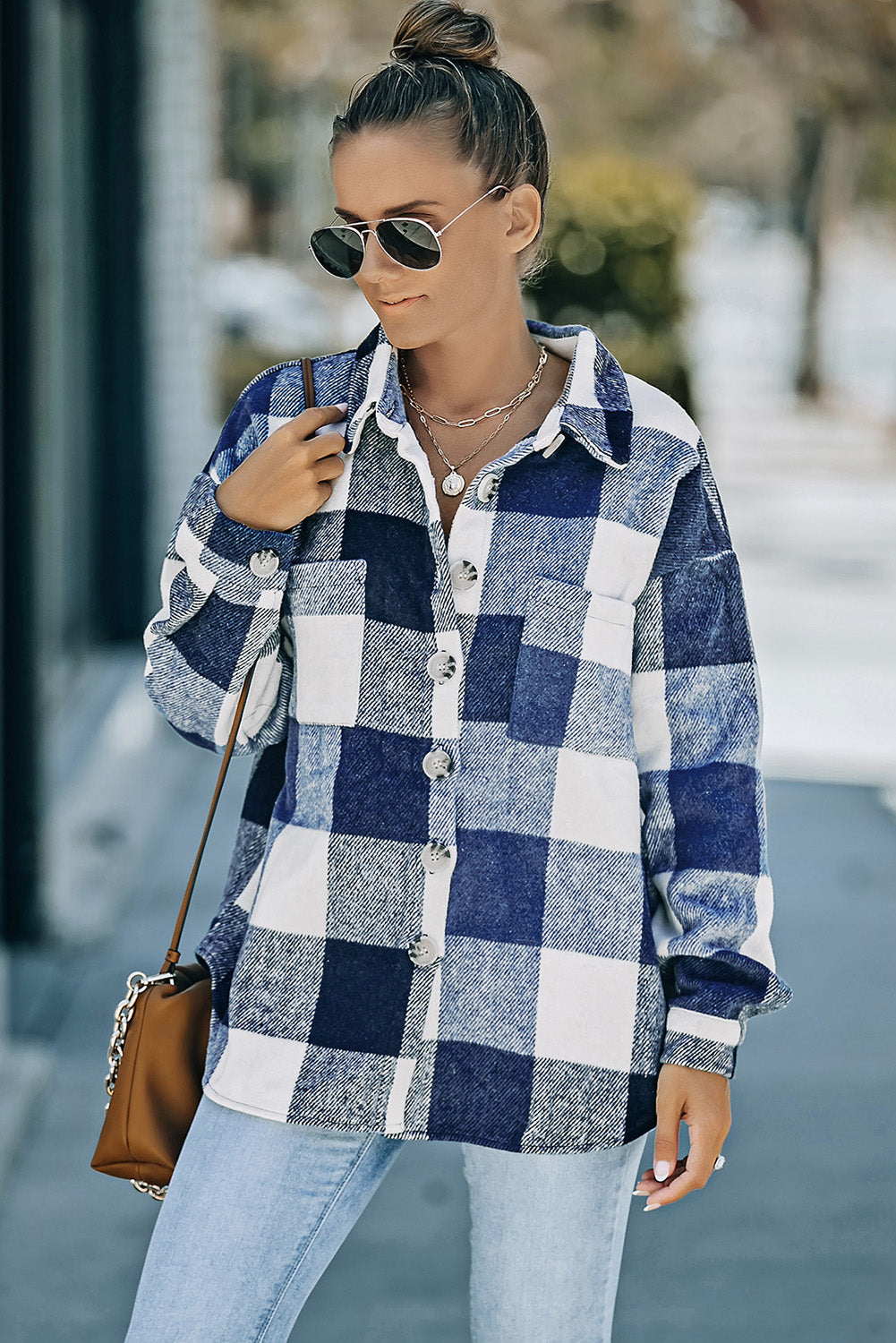 Oversized blue and white checkered shacket with button-down front and patch pocket.