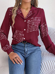 Burgundy collared blouse with white script pattern, button front, and long sleeves.