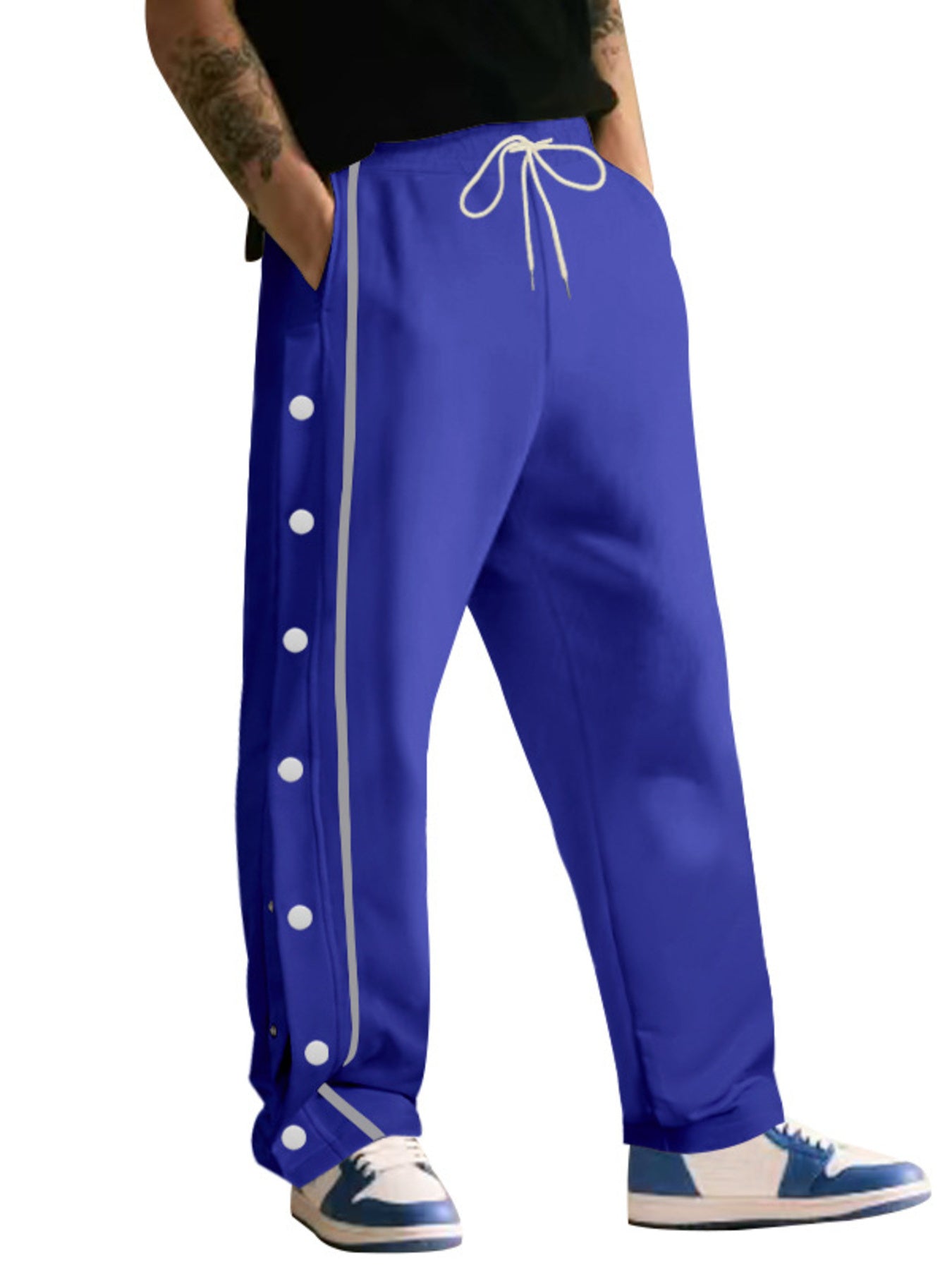 Royal blue track pants with snap buttons down the side and a drawstring waist.