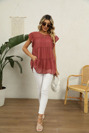 Swiss dot flutter sleeve tiered blouse in Brick Red with round neckline and short sleeves.
