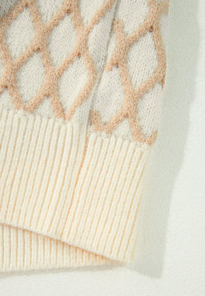 Diamond knit sweater in cream with ribbed cuffs and hem.