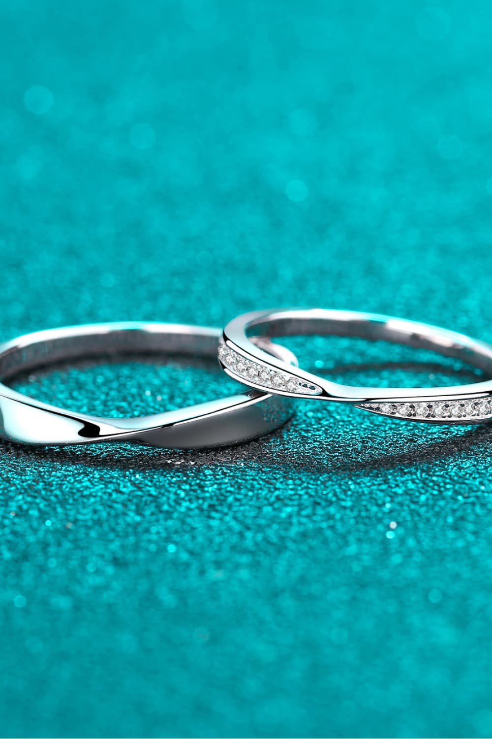 Silver band rings, one plain twisted, one with small clear stones