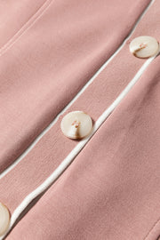 Dusty pink cardigan with varsity trim and button details