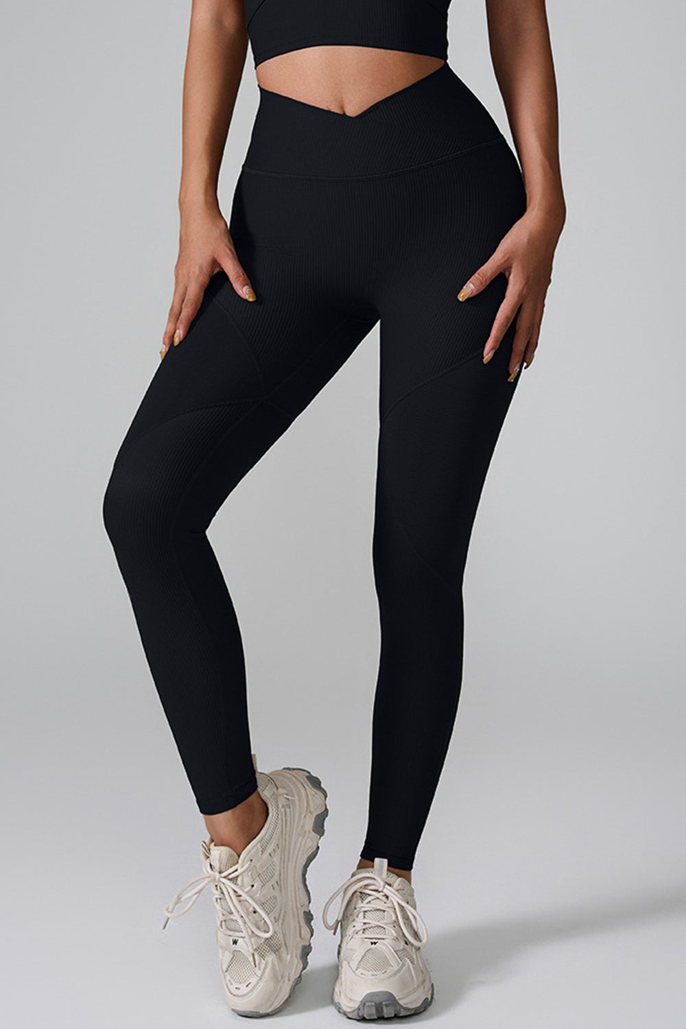 Black ribbed contour leggings with V-waist and paneled details.