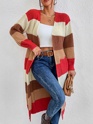 Striped knit maxi cardigan in red, orange, tan, and cream with pockets.