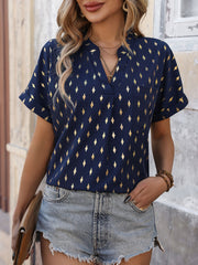 Dark blue blouse with gold diamond print, V-neck, short sleeves, and chest pocket.