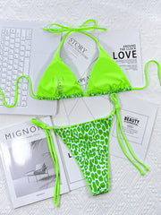 Green leopard print tie-side bikini set with ruffled trim.