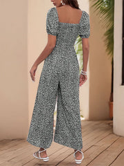 Smocked bodice floral wide-leg jumpsuit with puff sleeves and square neckline in Black White.