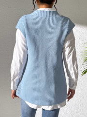 Light blue ribbed knit vest with a mock neck, styled over a white shirt.