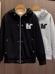 Men's black zippered hoodie with buttoned pockets and embroidered detail.