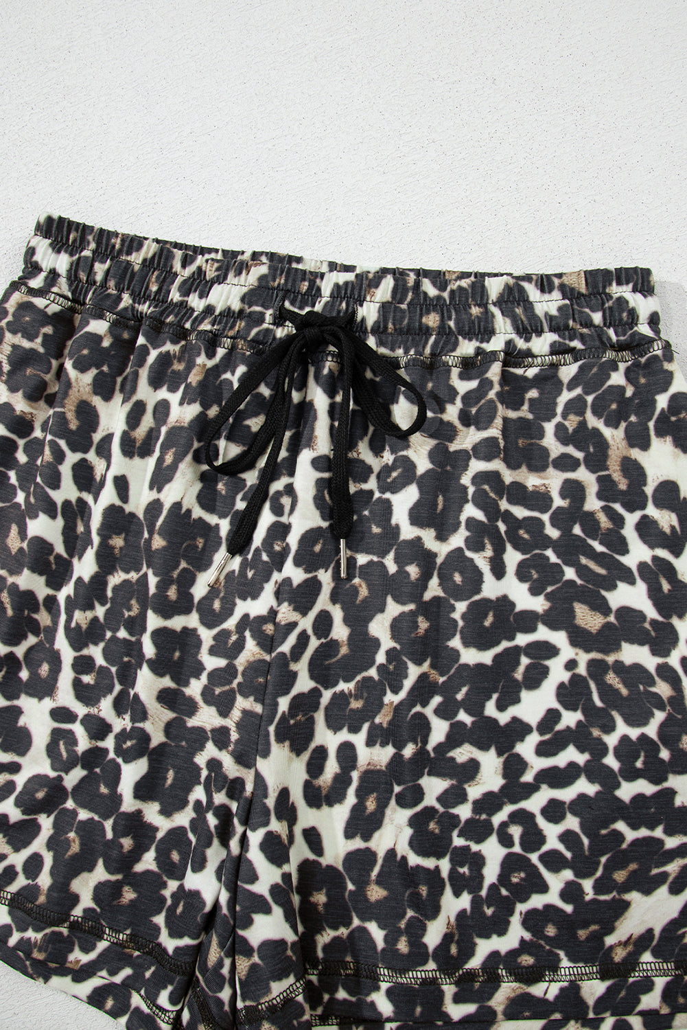 Leopard print lounge shorts with elastic waistband and drawstring.