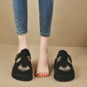 Black embroidered denim platform clogs with buckle detail