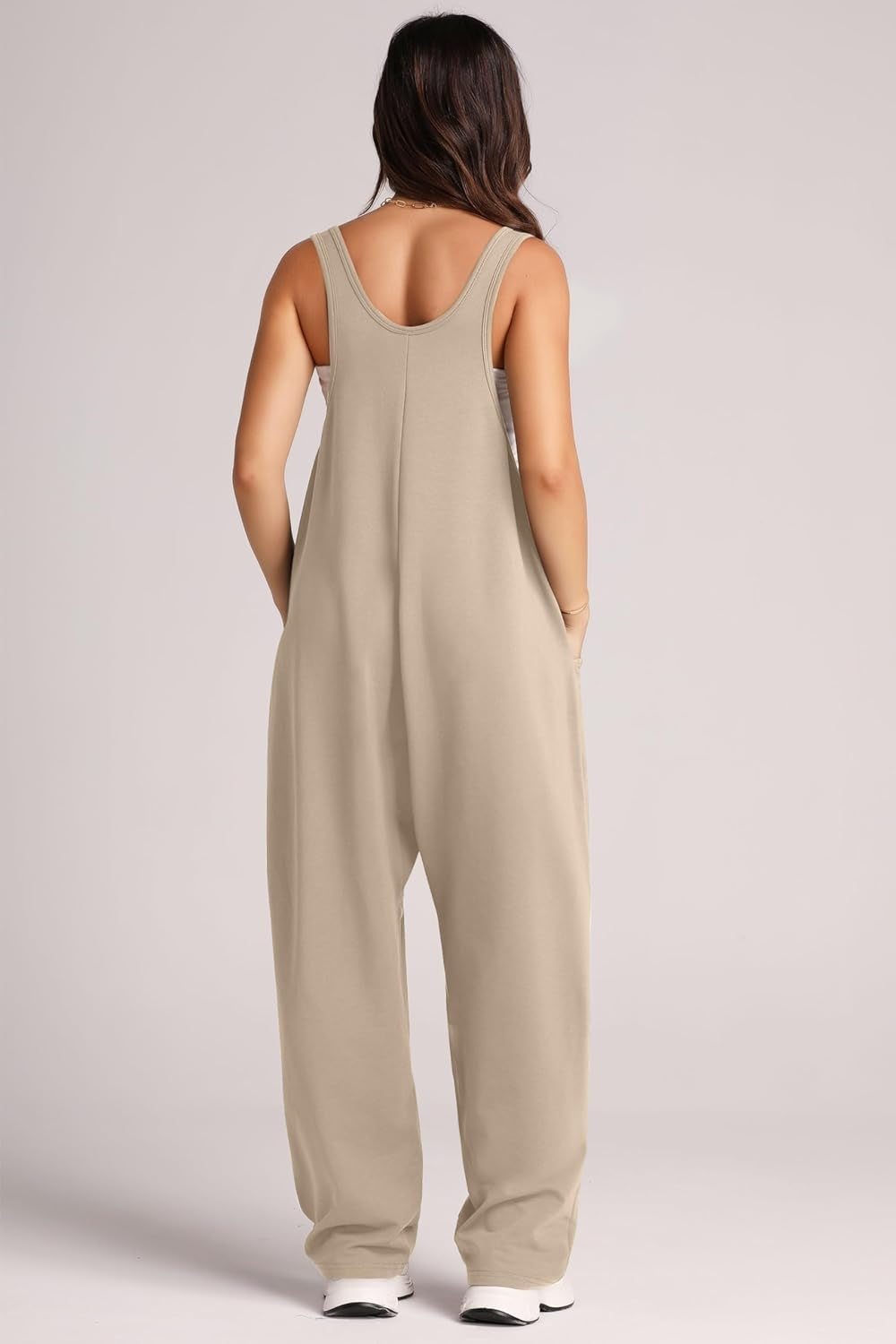 Khaki relaxed fit jumpsuit with oversized pockets and scoop neckline.