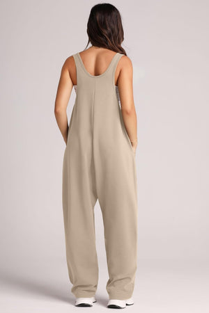 Khaki relaxed fit jumpsuit with oversized pockets and scoop neckline.