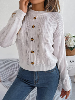 White cable knit button-up sweater with tortoise buttons and open knit details
