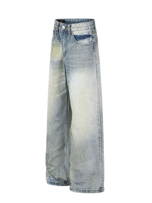 Men's light blue wide leg denim jeans with vintage wash and distressed details.
