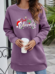 Purple graphic tunic sweatshirt with "Don't Stop Believing" holiday print and crew neck.