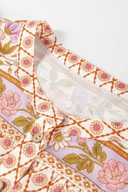 Bohemian floral print blouse with button front and blouson sleeves.