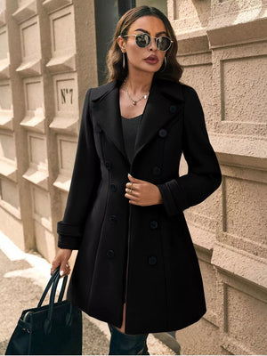 Black double-breasted wool blend trench coat with cuffed sleeves and a-line cut.