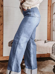 Light blue denim wide-leg jeans with buttoned pockets and cuffed hems.