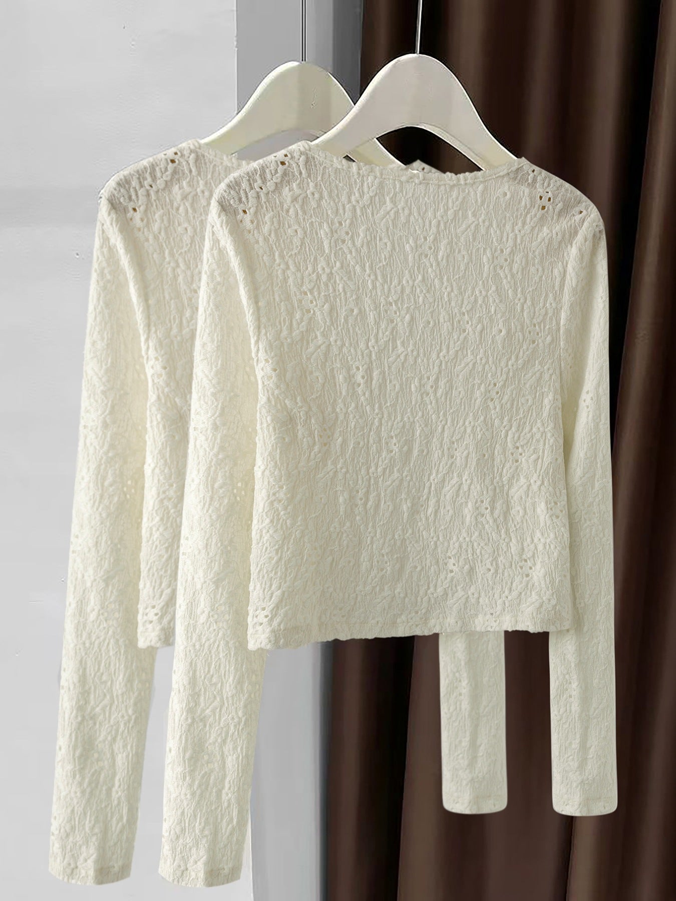 Lace button-up cardigan in cream with delicate textured pattern and long sleeves.