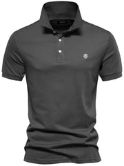 Gray cotton polo shirt with embroidered crest detail and button placket.