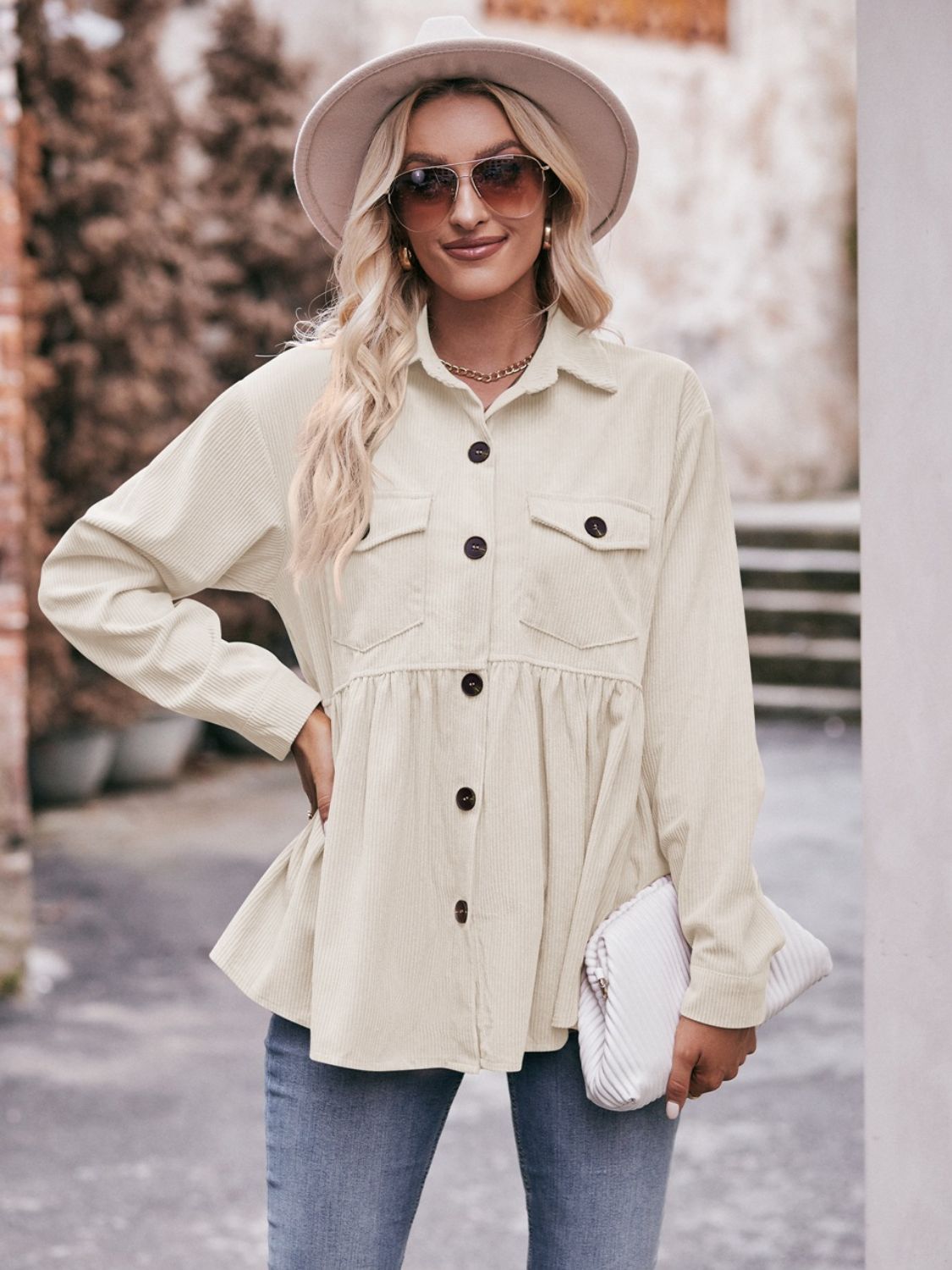 Beige corduroy peplum shirt jacket with button front and chest pockets, styled casually.